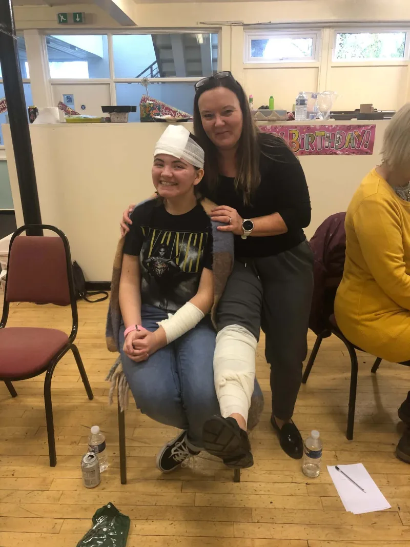 Pam with a participant after a practical bandaging exercise